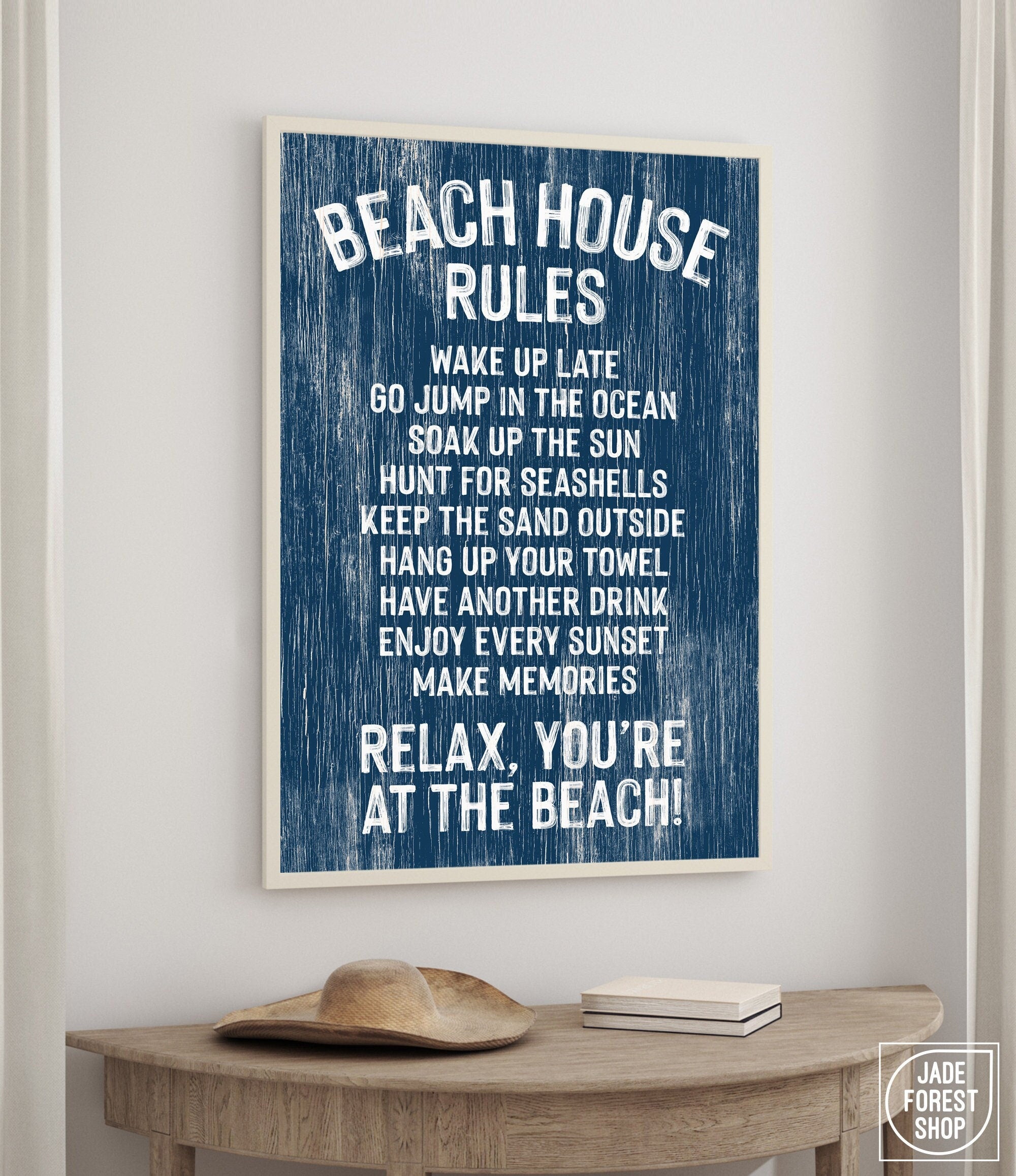 The Beach House Rules Sign, Painted Wood, Nautical, adds relaxed coastal decor above a table with a hat and books.