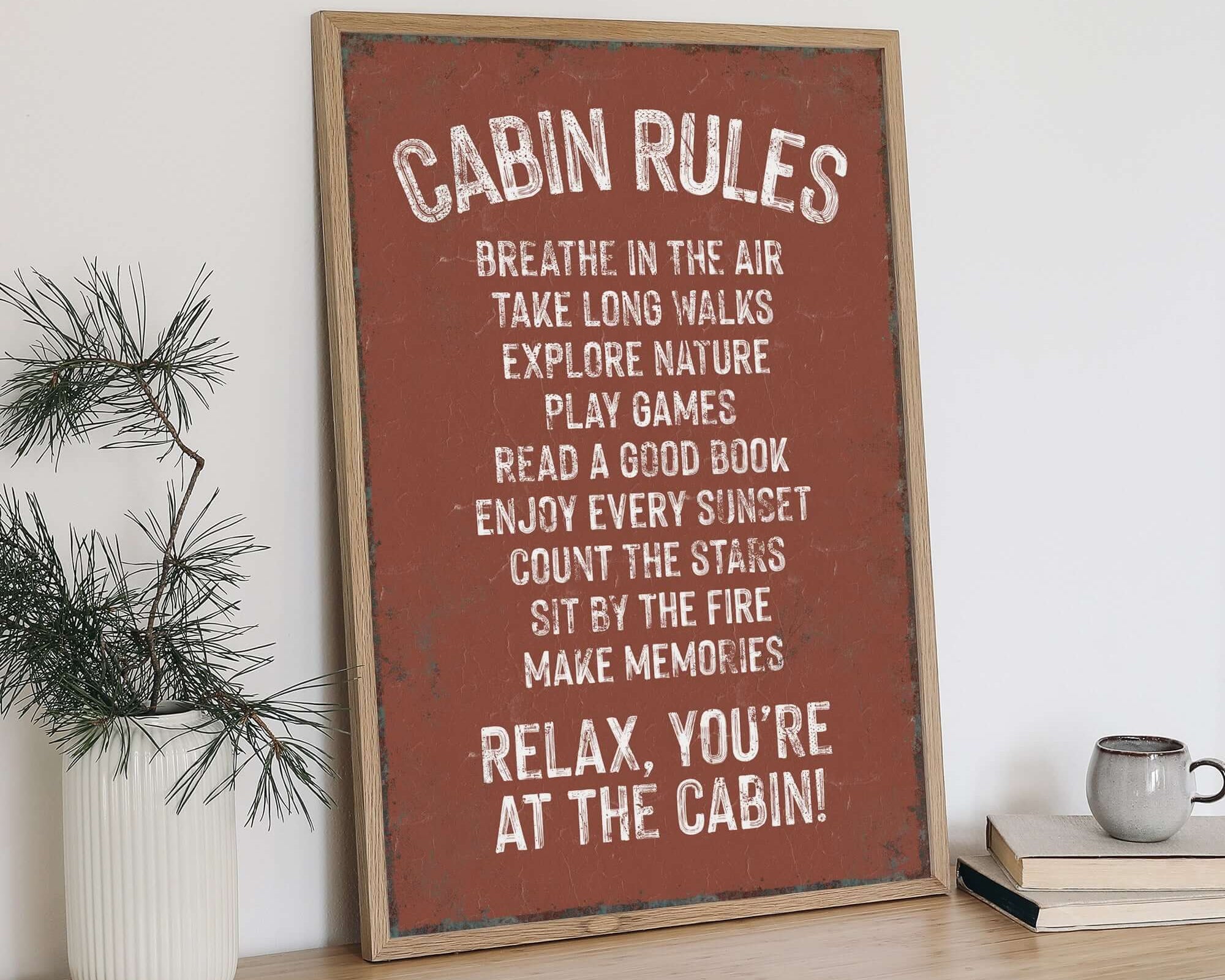 a wooden table topped with a sign and a potted plant
