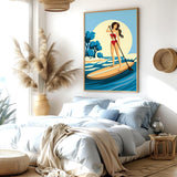 a bedroom with a large bed, a potted plant, and a framed illustration of a woman paddleboarding on a blue ocean.