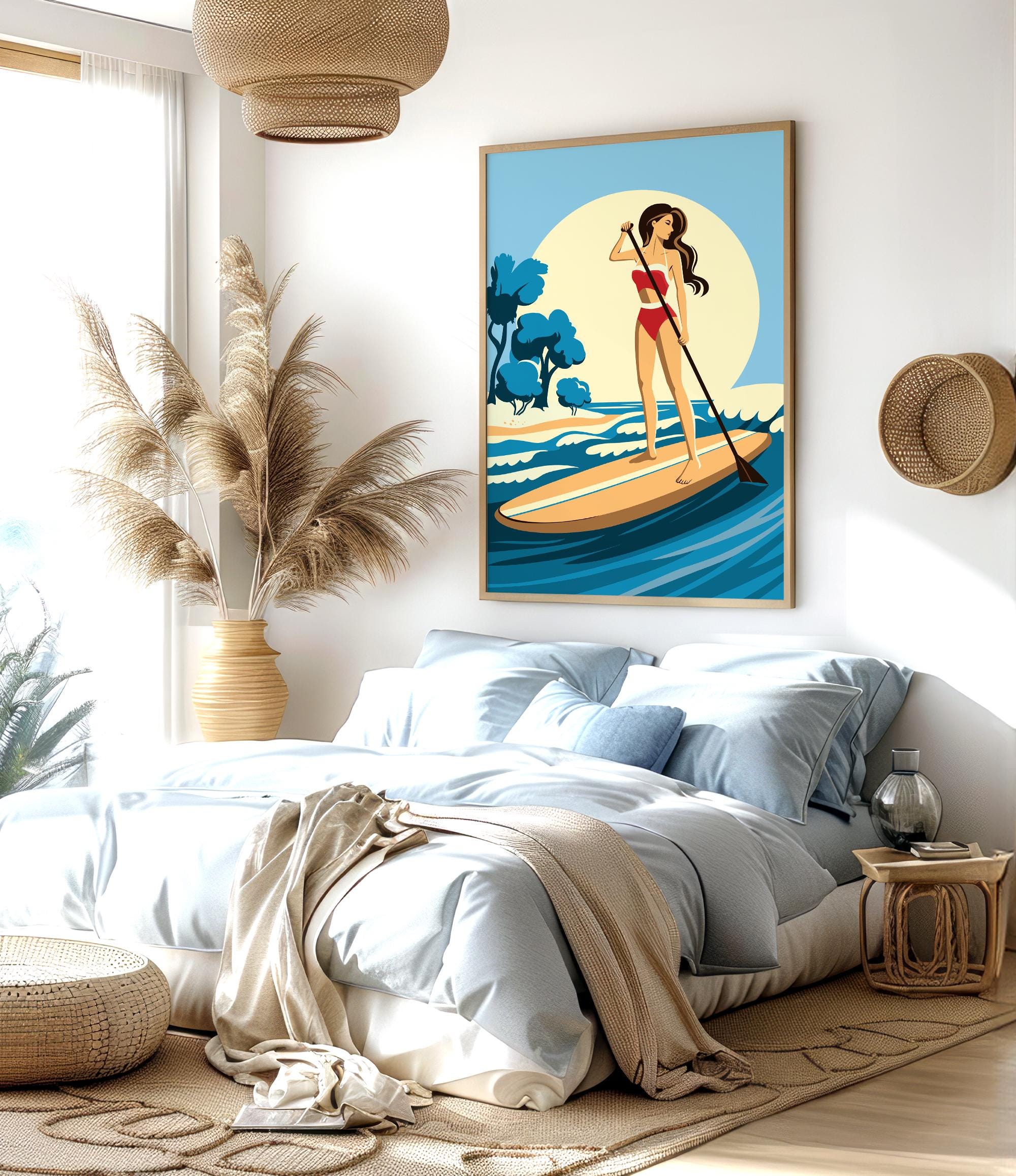 a bedroom with a large bed, a potted plant, and a framed illustration of a woman paddleboarding on a blue ocean.