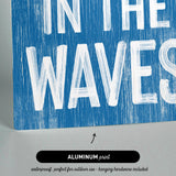 a blue sign that says in the waves