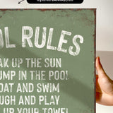 a hand holding a sign that says pool rules