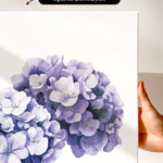 a close-up of a white canvas print with a vibrant purple flower design.