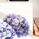 a close-up of a white canvas print with a vibrant purple flower design.