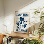 a sign that says slow down no wake zone idle speed