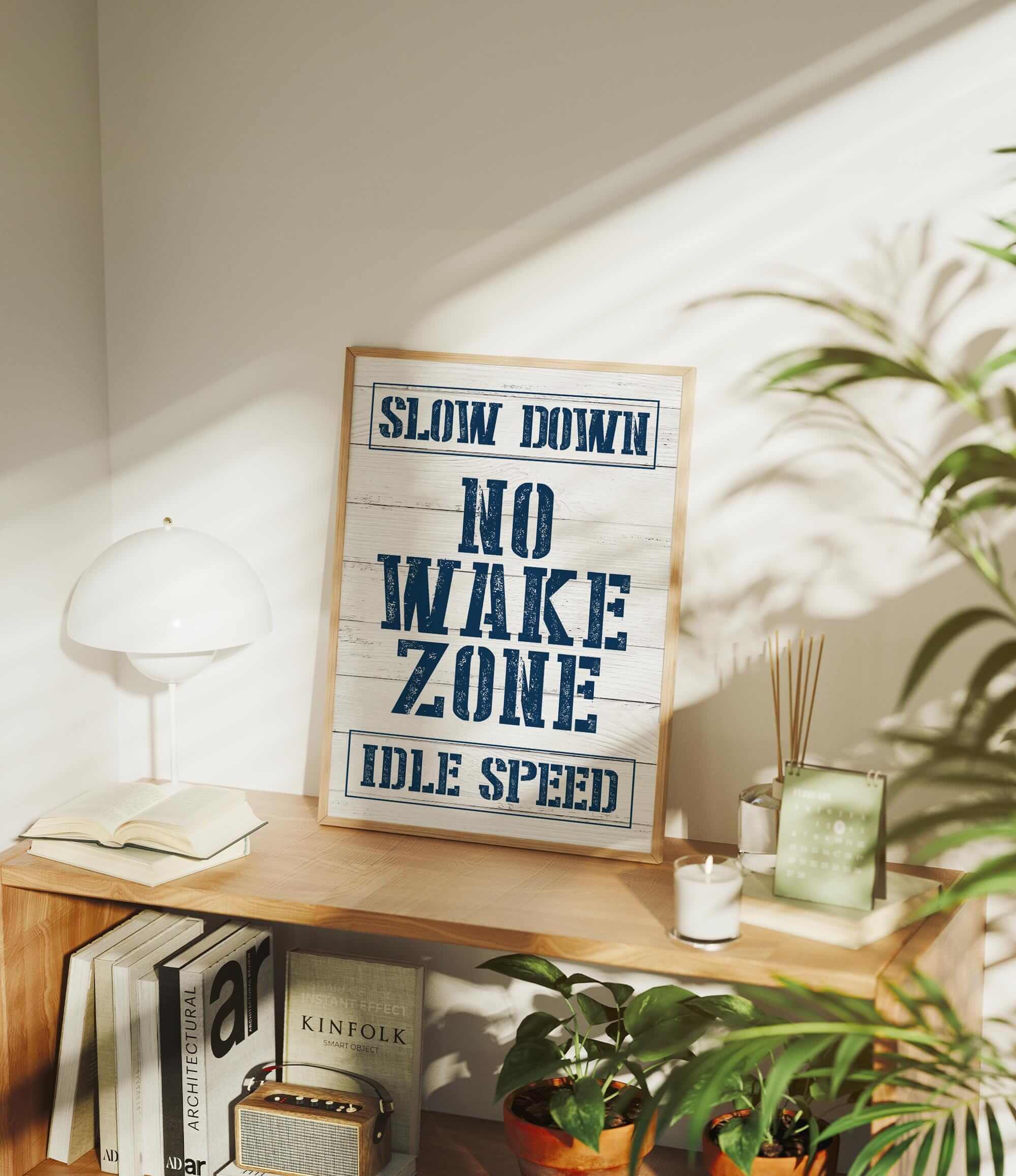 a sign that says slow down no wake zone idle speed