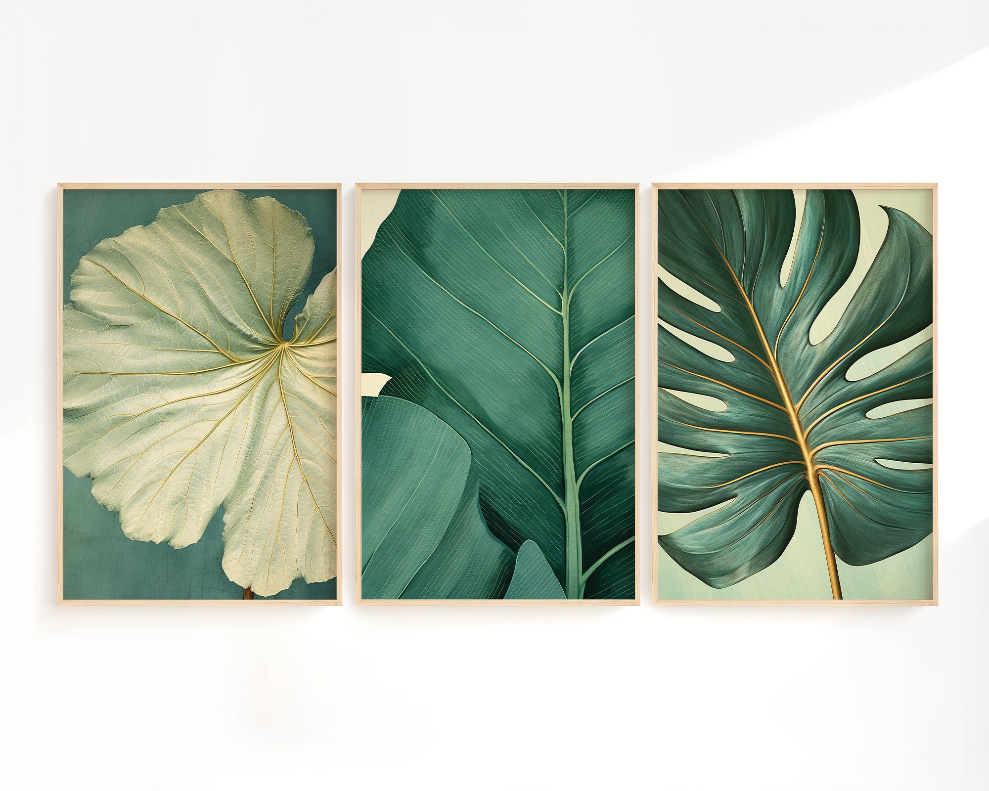 three framed botanical illustrations of tropical leaves, each with a distinct color scheme and leaf shape.