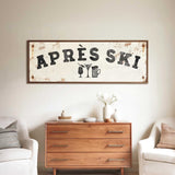 a rustic wooden dresser with a vintage-style sign hanging above it, which reads "APRÈS SKI". The dresser is situated between two white chairs, creating a cozy and inviting atmosphere.