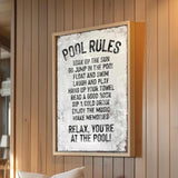 a picture of a pool rules sign hanging on a wall
