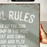 a hand holding a sign that says pool rules
