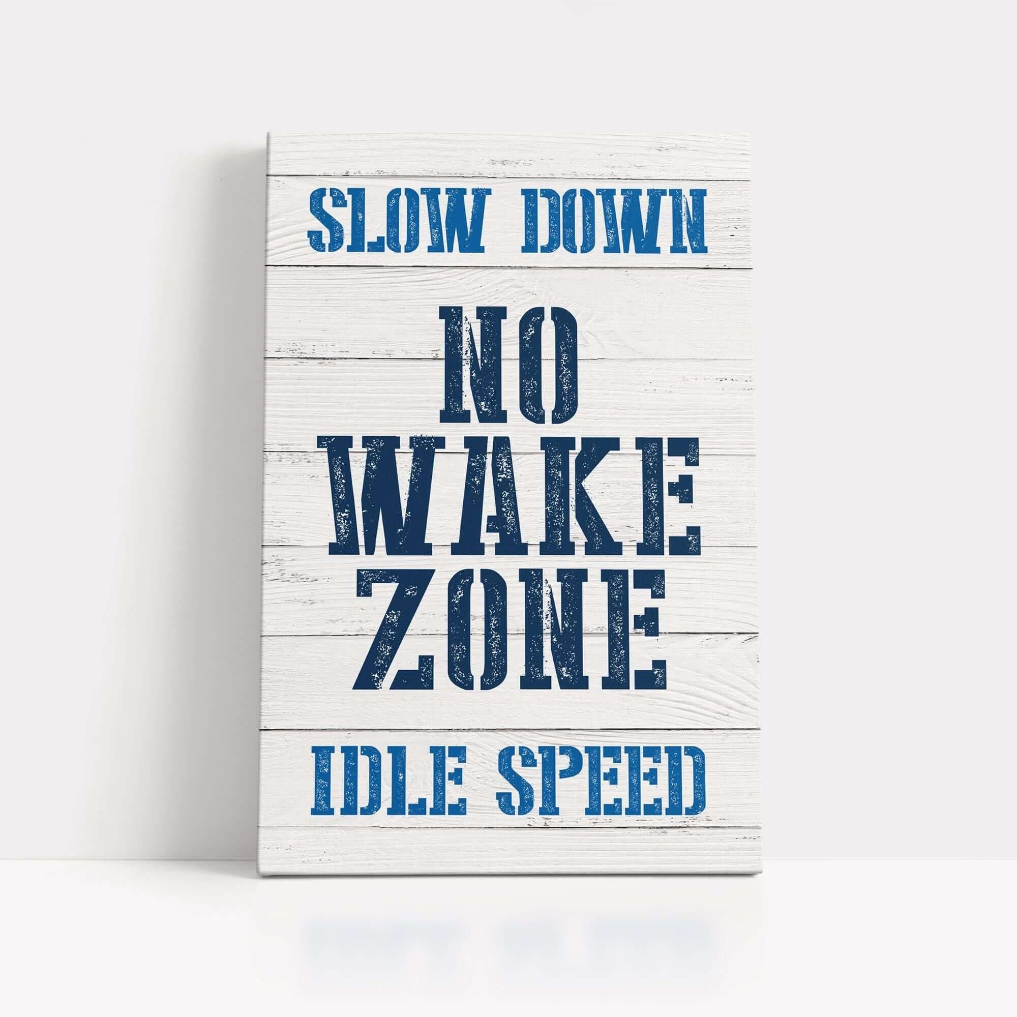 a wooden sign that says slow down no wake zone