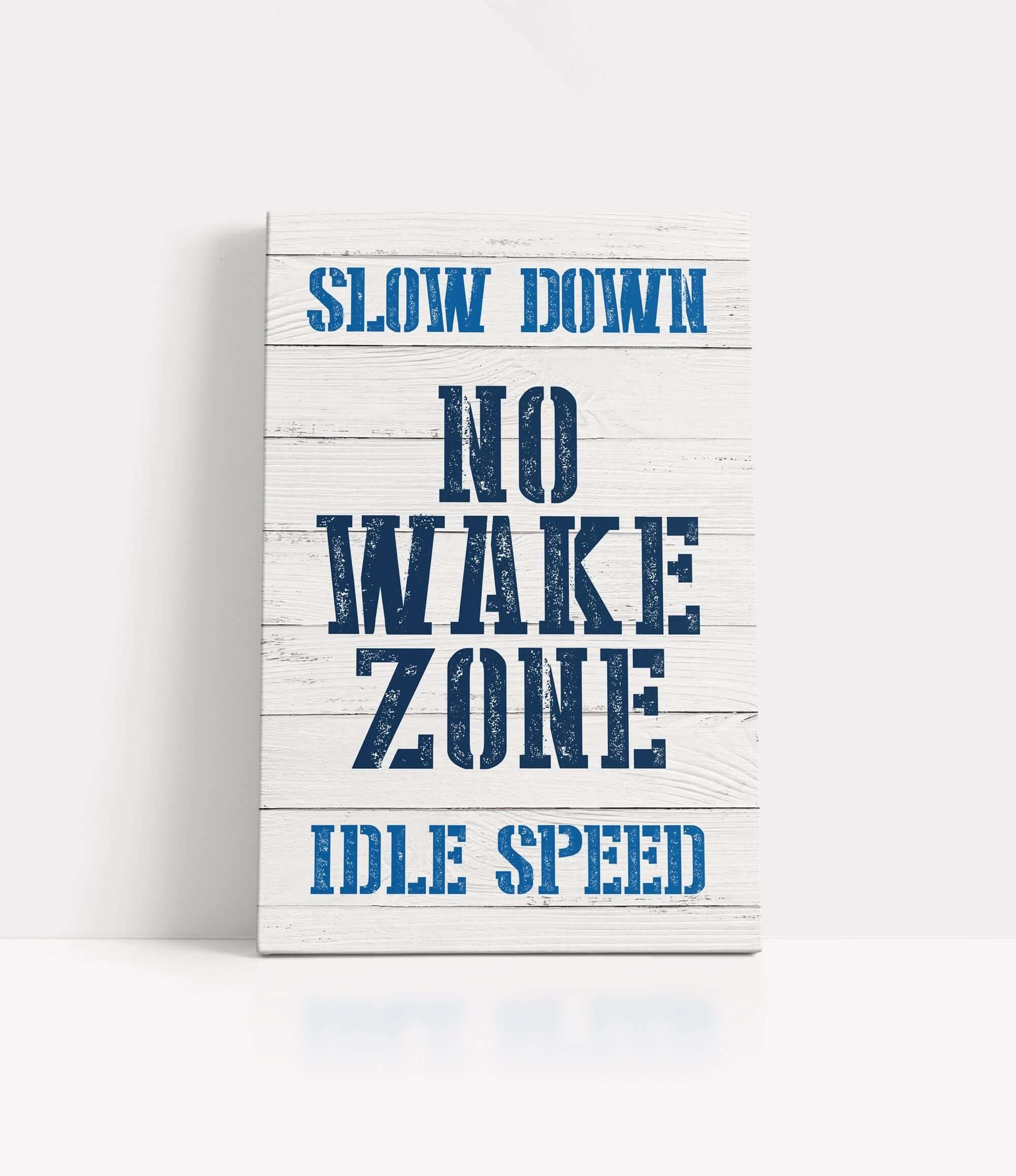 a wooden sign that says slow down no wake zone
