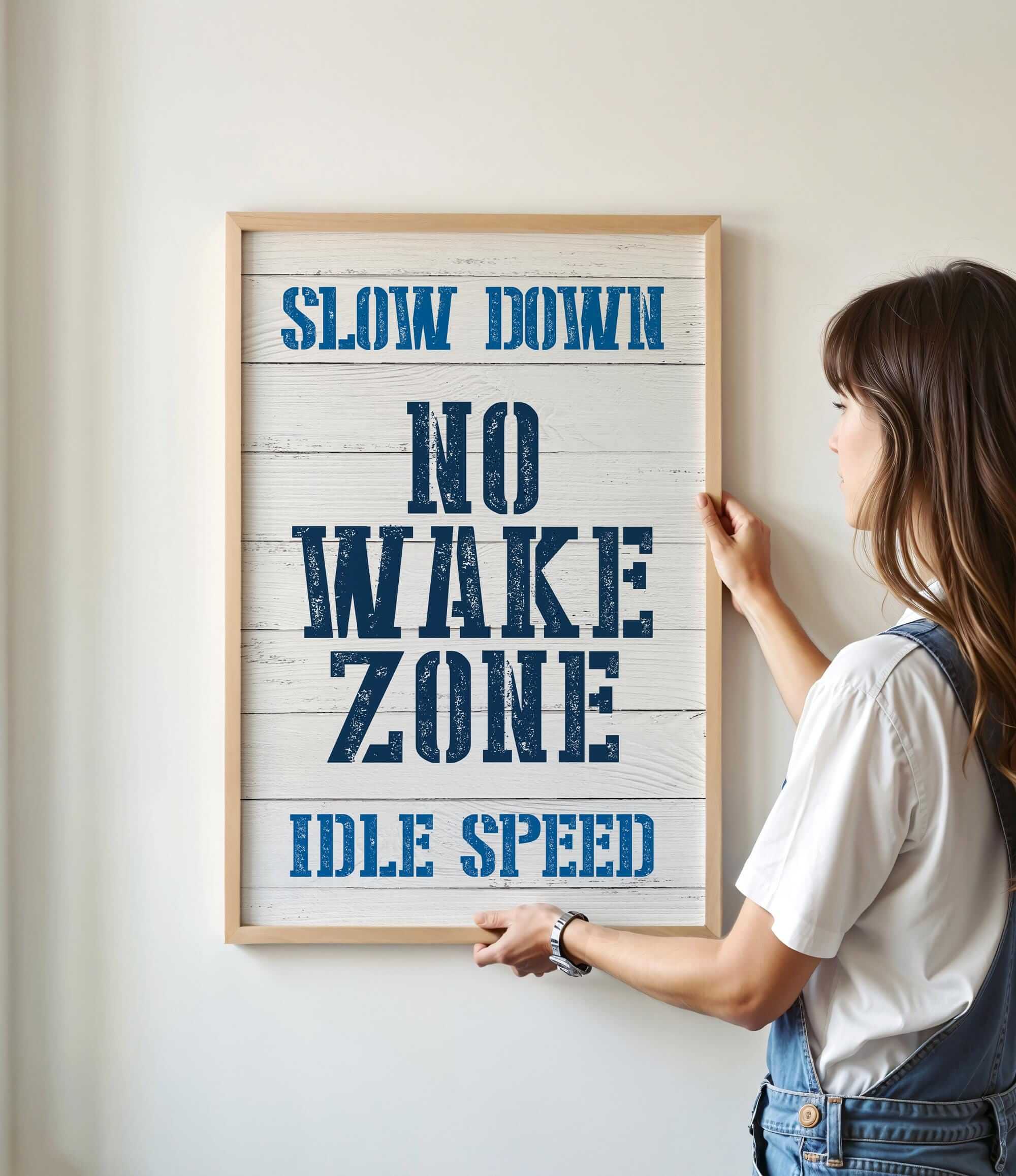 a woman holding a sign that reads slow down no wake zone idle speed