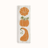 a wooden sign with three pumpkins on it