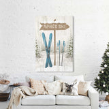A cozy living room featuring a white sofa, festive holiday decor, and the Cerulean Après Ski Signpost Wall Art above the couch—perfect for mountain lodge style.