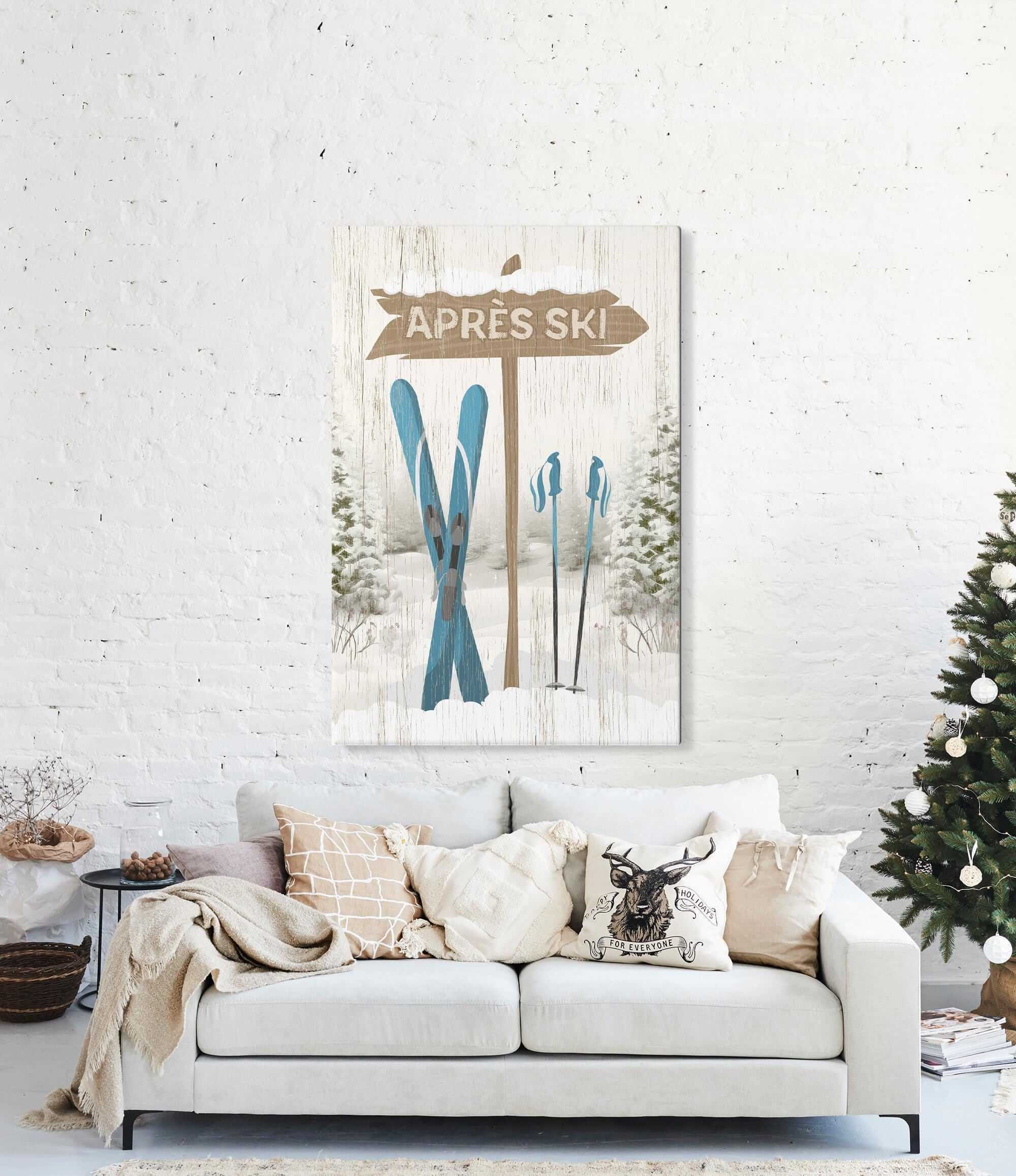 A cozy living room featuring a white sofa, festive holiday decor, and the Cerulean Après Ski Signpost Wall Art above the couch—perfect for mountain lodge style.
