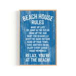 The Beach House Rules Sign in painted ocean blue wood displays relaxed coastal guidelines with white text, including "Relax, you're at the beach!"—the perfect piece of coastal wall art.
