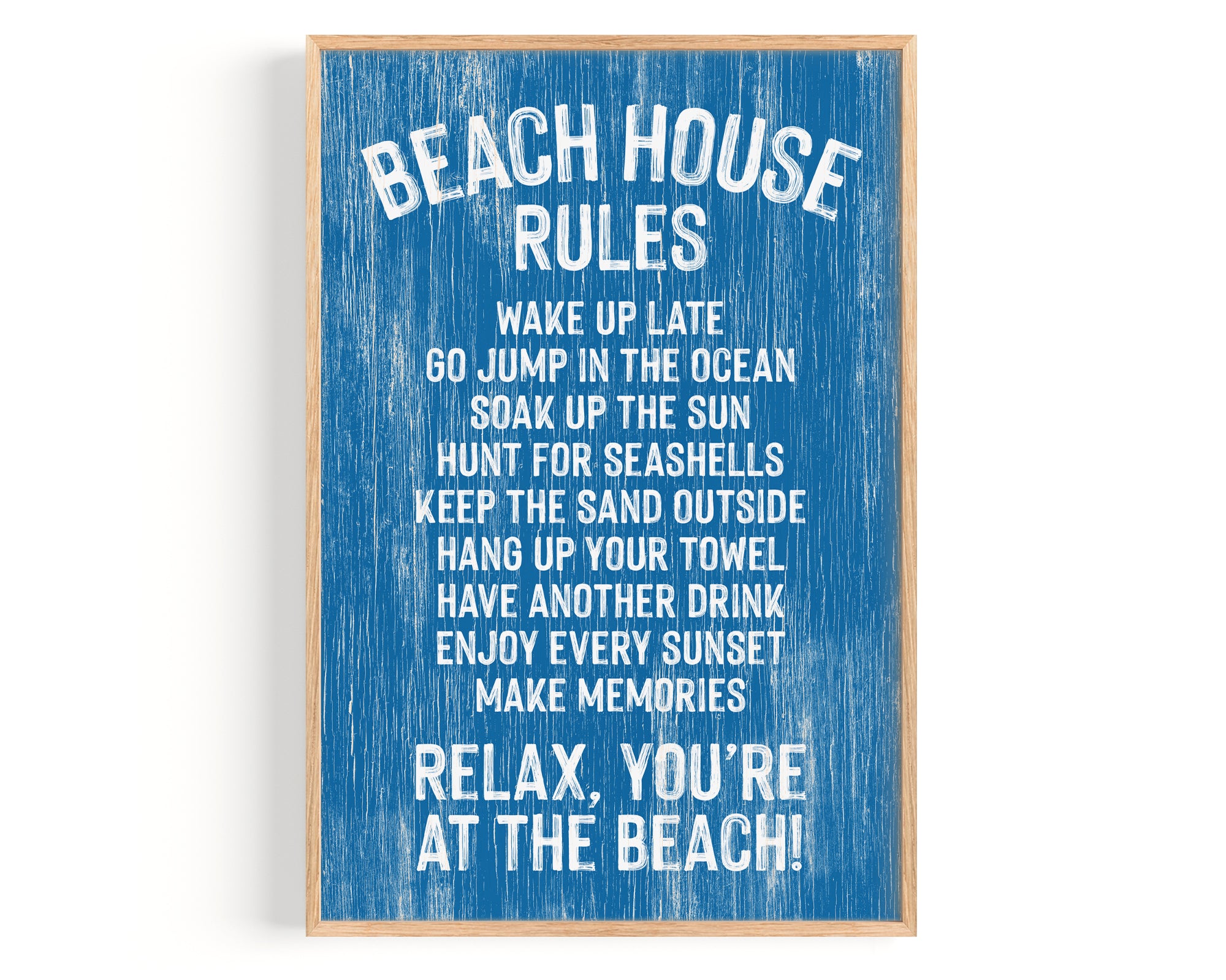 The Beach House Rules Sign in painted ocean blue wood displays relaxed coastal guidelines with white text, including "Relax, you're at the beach!"—the perfect piece of coastal wall art.