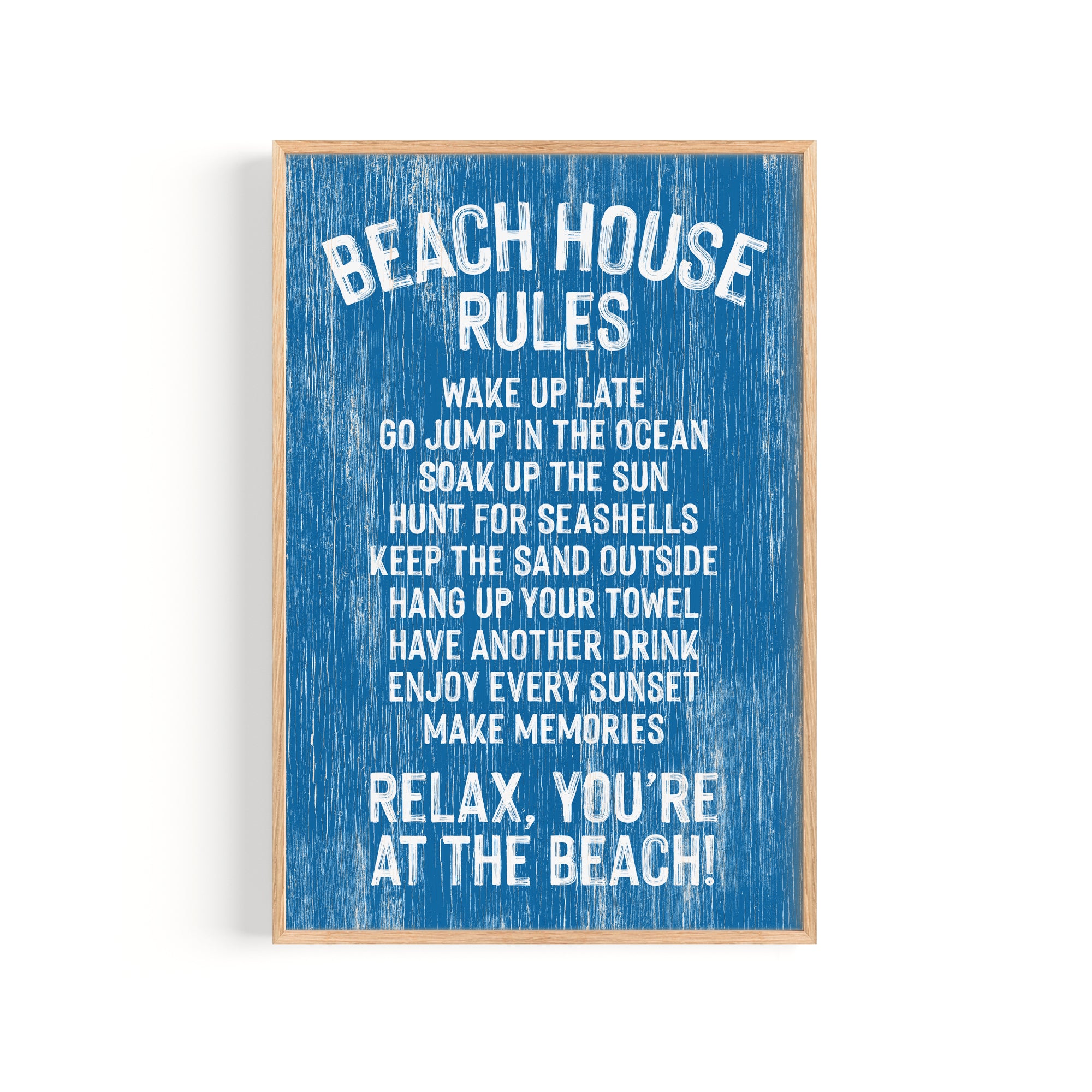 The Beach House Rules Sign in painted ocean blue wood displays relaxed coastal guidelines with white text, including "Relax, you're at the beach!"—the perfect piece of coastal wall art.