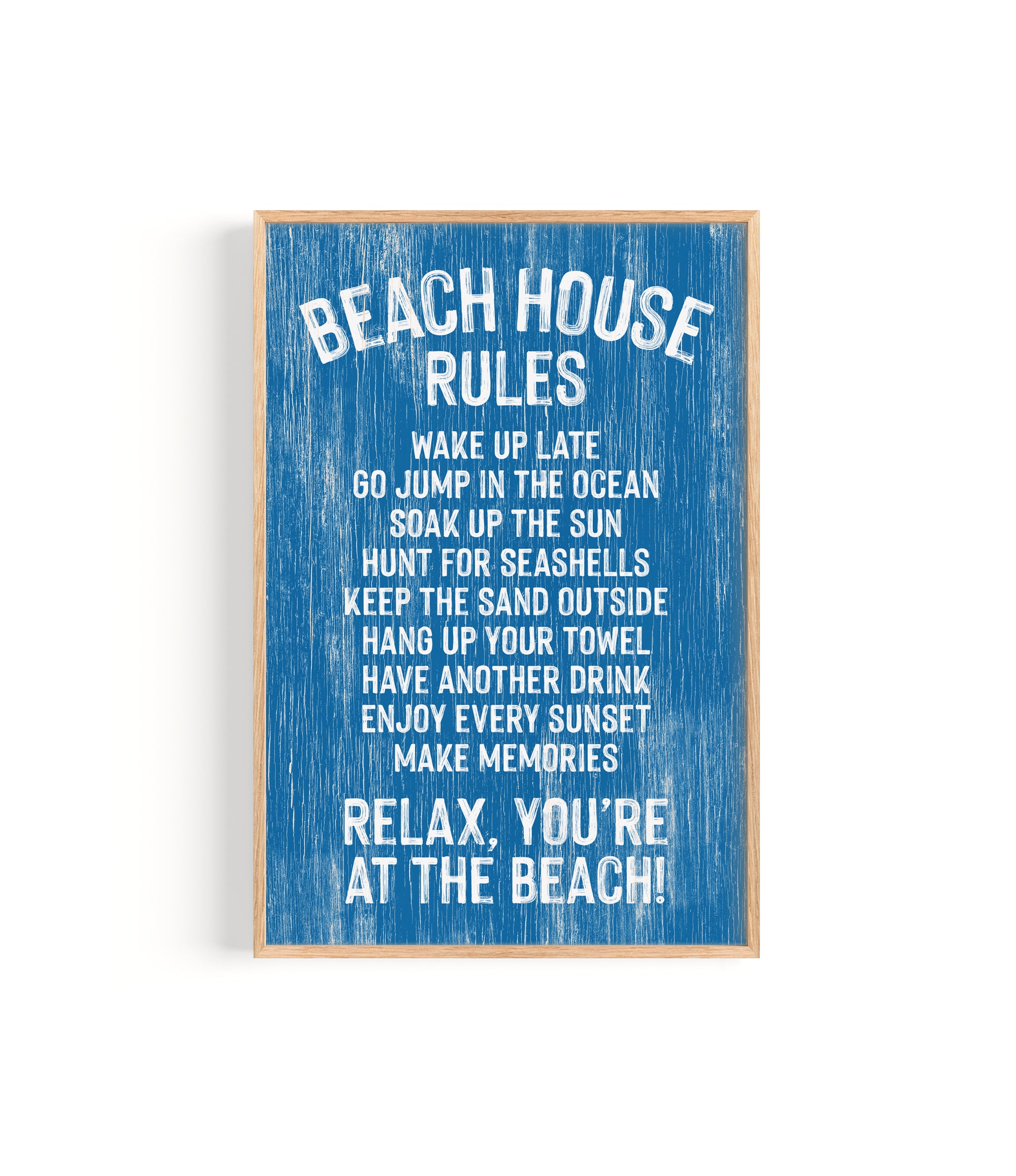 The Beach House Rules Sign in painted ocean blue wood displays relaxed coastal guidelines with white text, including "Relax, you're at the beach!"—the perfect piece of coastal wall art.