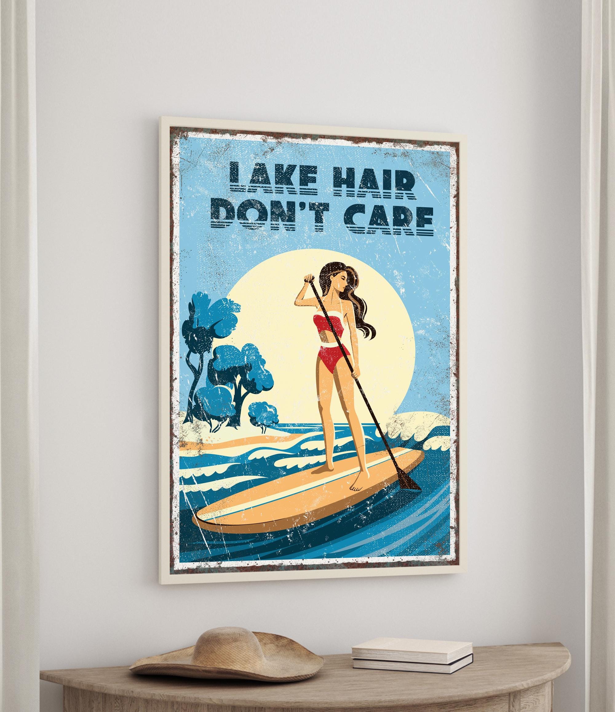 a woman paddleboarding on a lake, with the text "LAKESHAIR DON'T CARE" displayed above her.