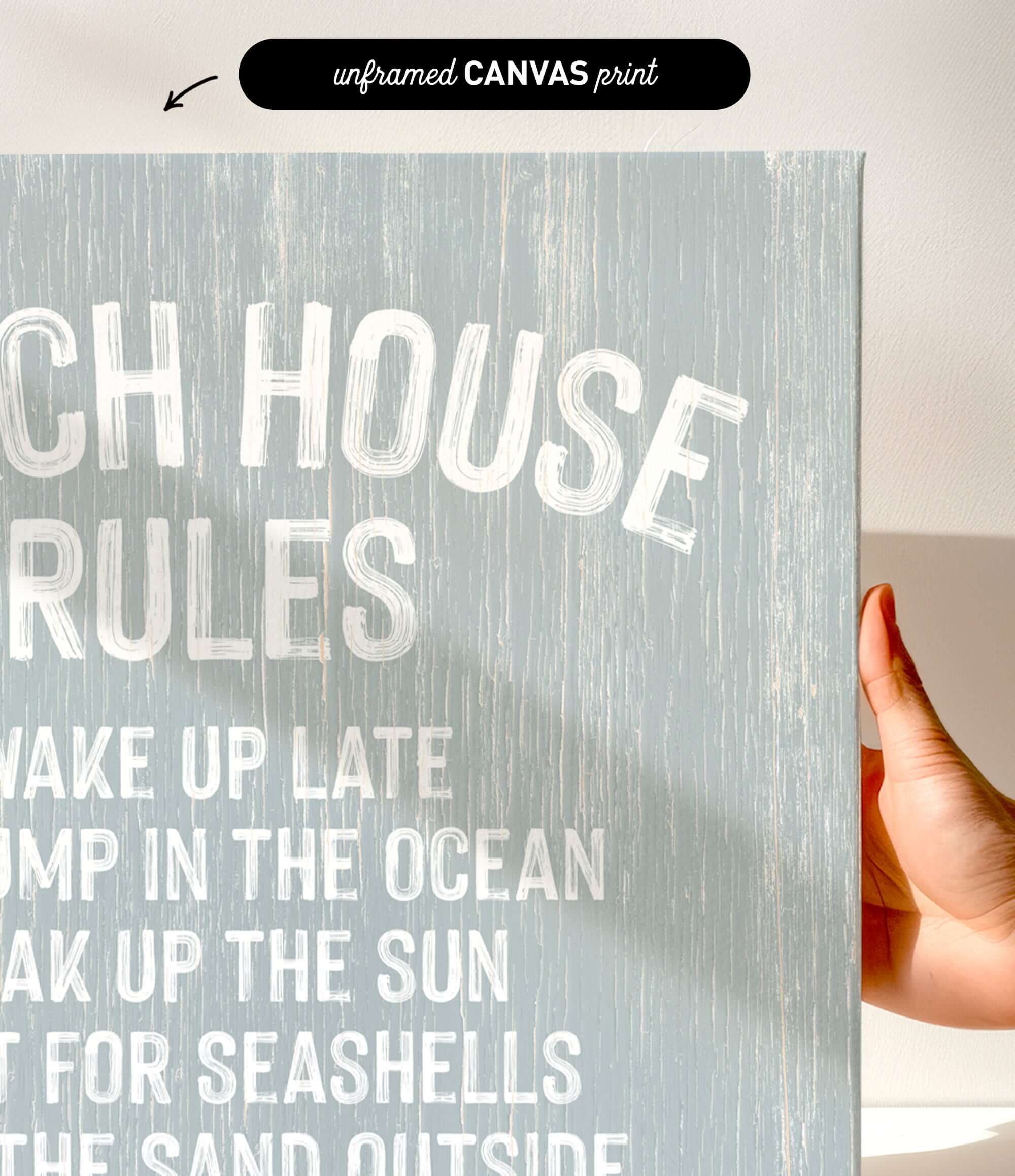 a hand holding a canvas print with the text "CHEACH HOUSE RULES" written on it.