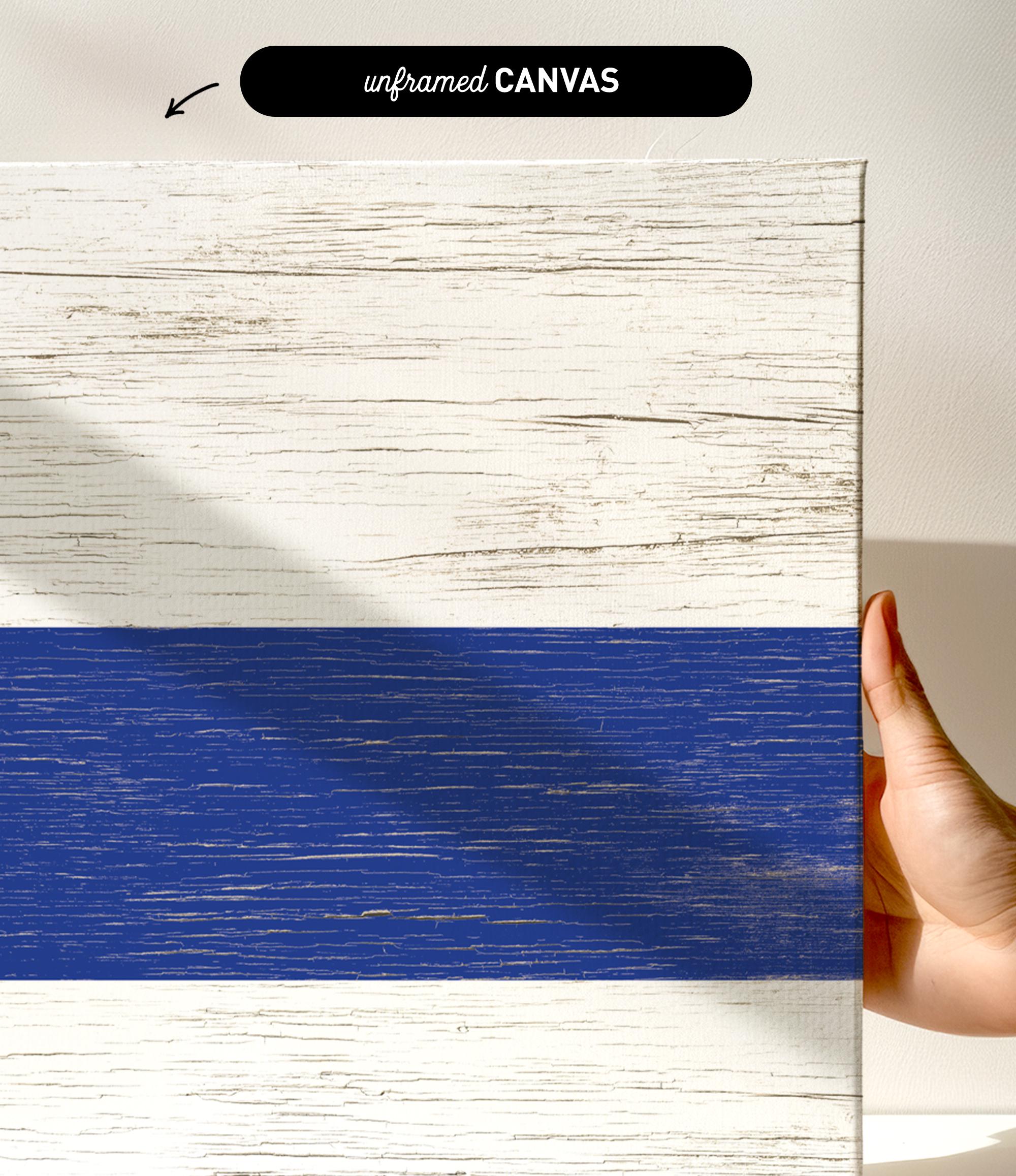 a hand holding a piece of wood with a blue strip painted on it