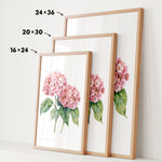 three framed prints of a watercolor painting of pink hydrangeas, each with a different size and frame.