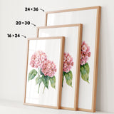 three framed prints of a watercolor painting of pink hydrangeas, each with a different size and frame.