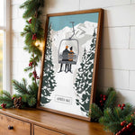 A framed illustration of a ski lift carrying two people is displayed on a wooden dresser, surrounded by Christmas decorations.
