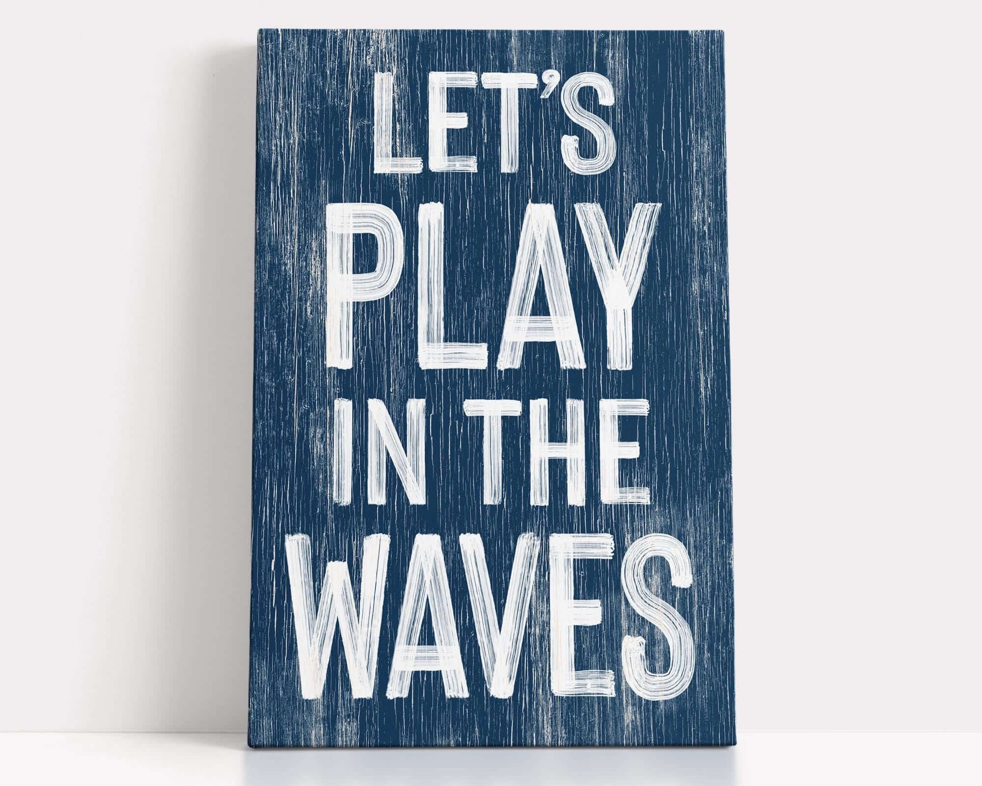 a wooden sign that says let's play in the waves