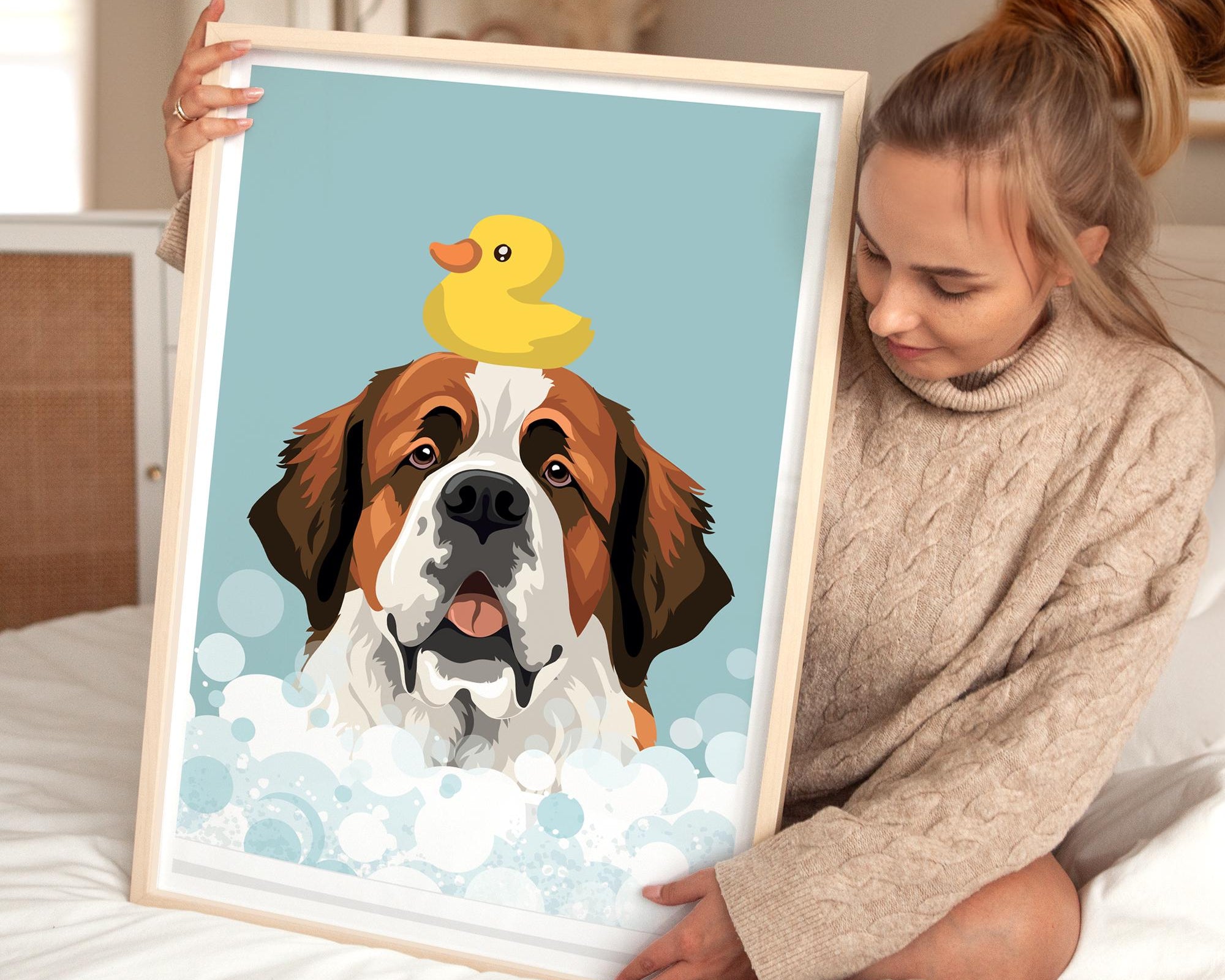 A woman is holding a framed picture of a dog with a yellow rubber duck on its head, which is sitting in a bubble of water.