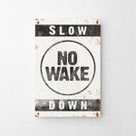 a sign that says slow no wake down