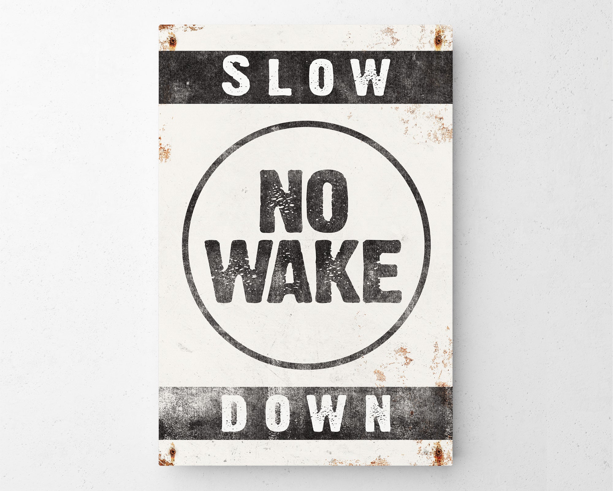 a sign that says slow no wake down