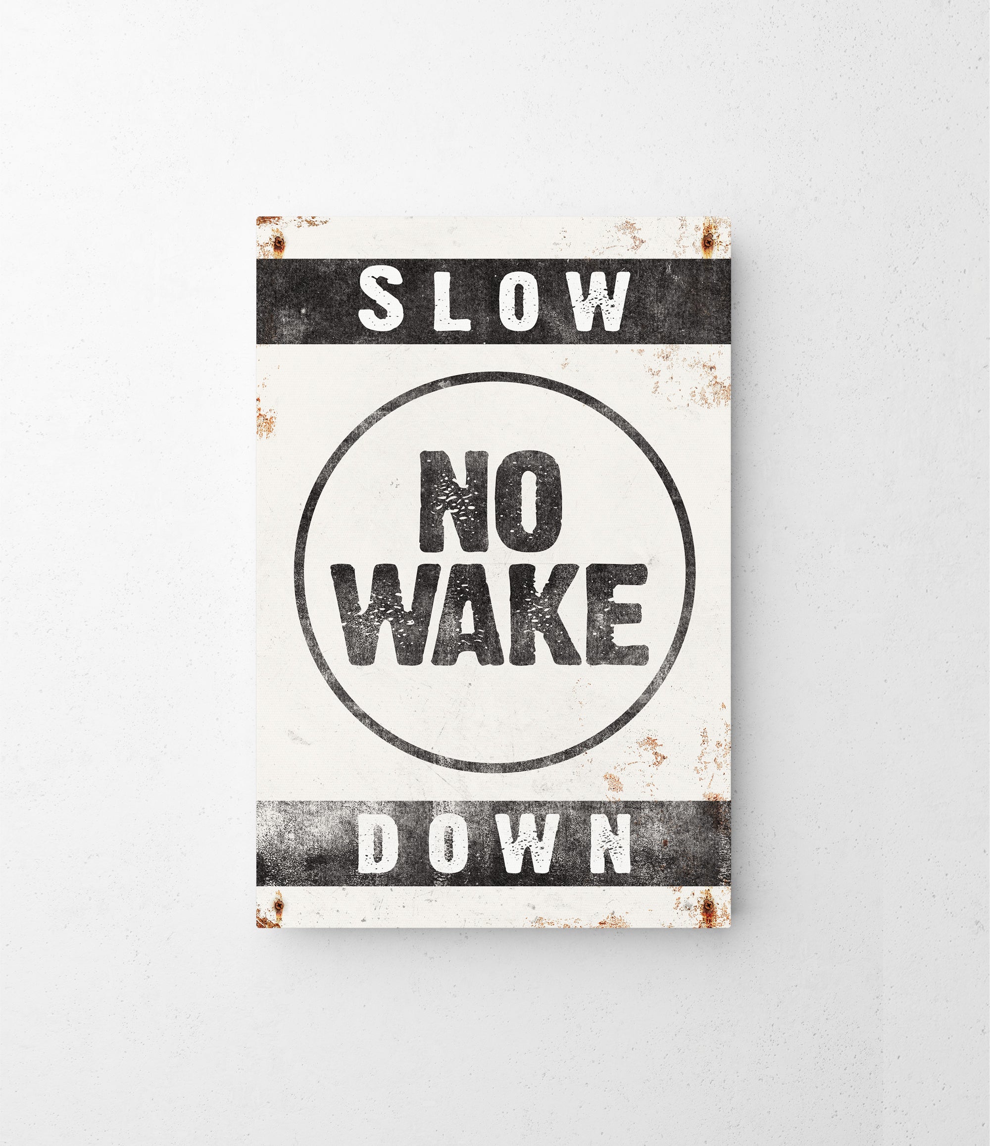 a sign that says slow no wake down