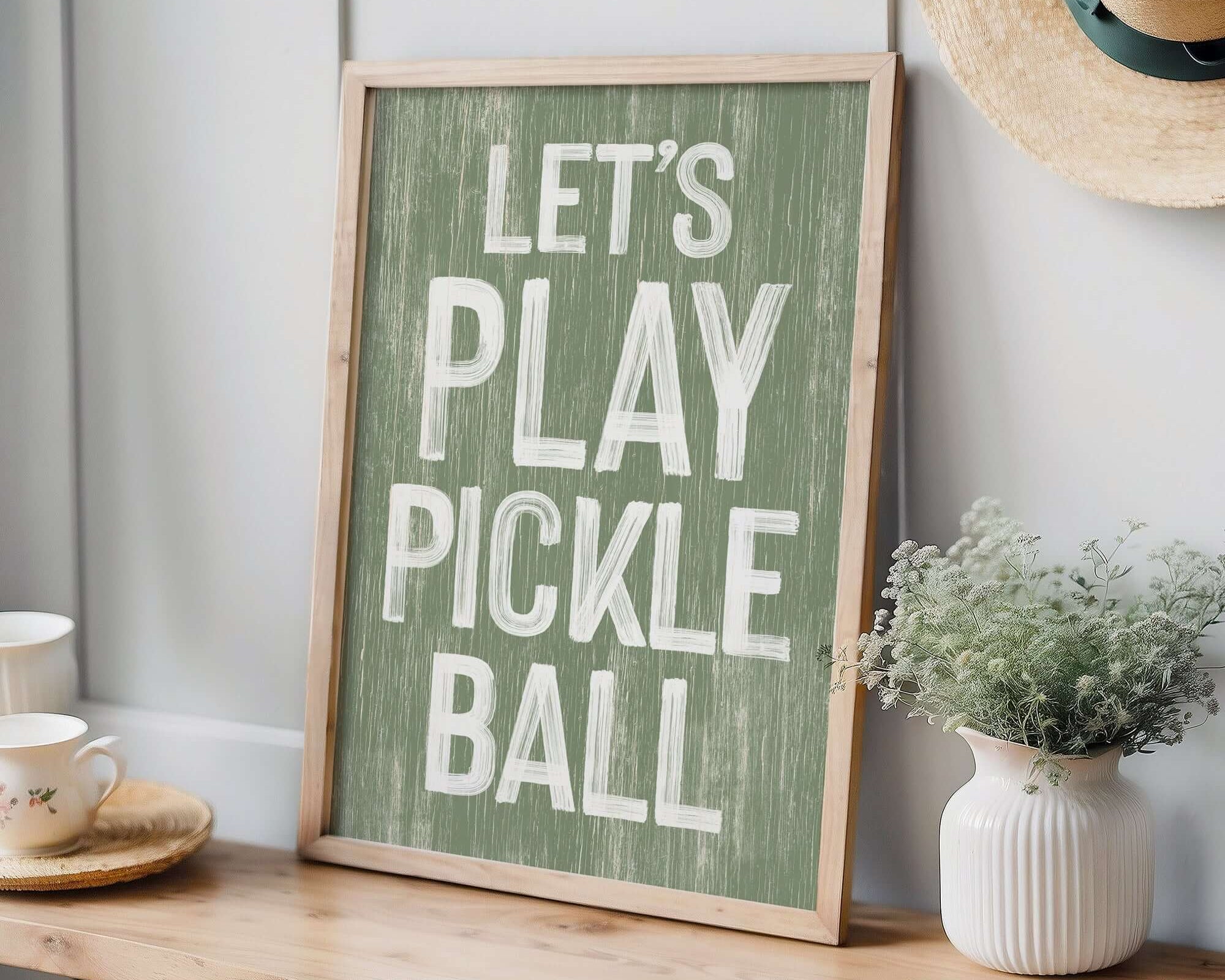 a wooden sign that says let's play pickle ball