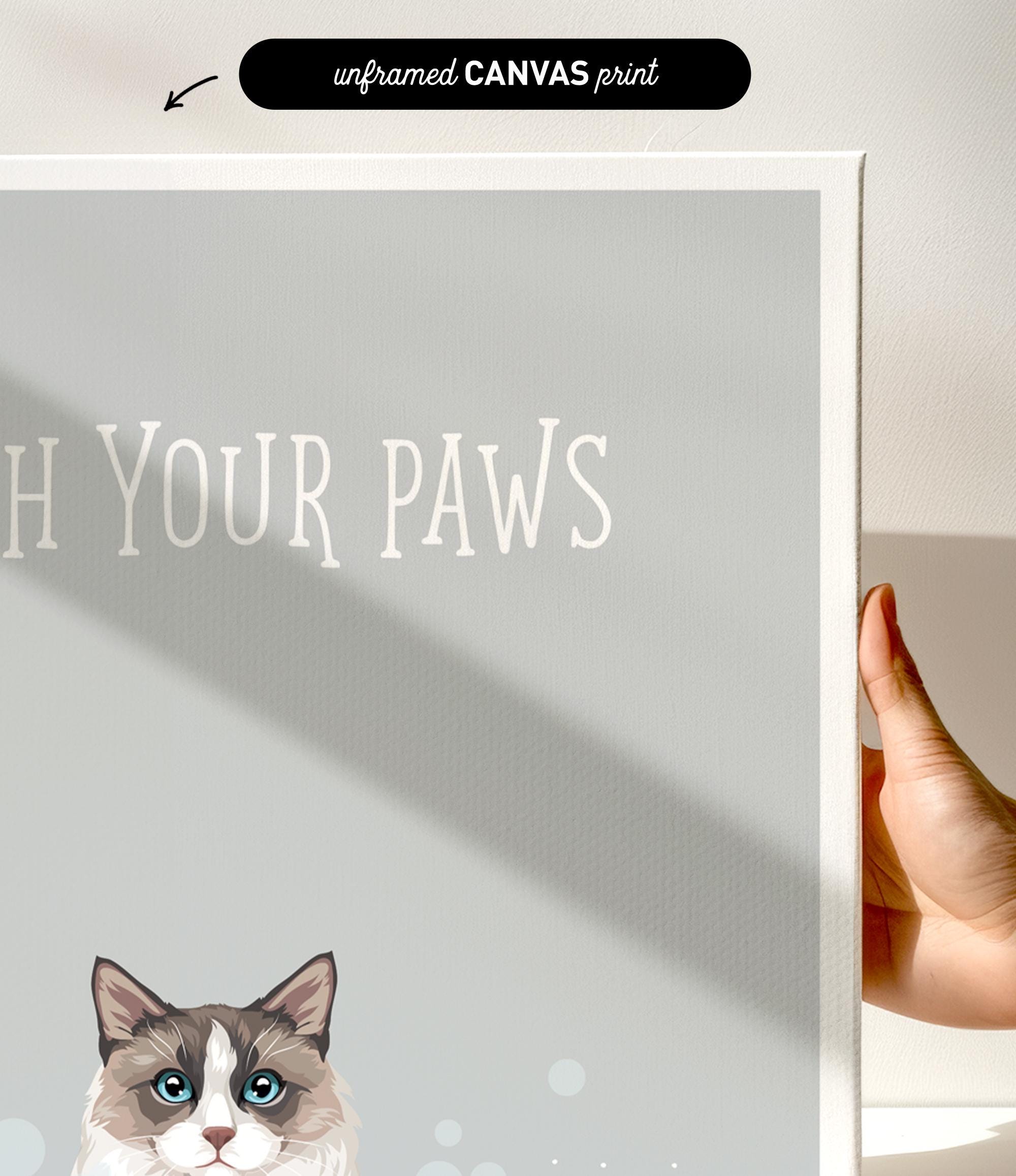 a gray and white cat with blue eyes, and the text "Witch Your Paws" is displayed on the canvas print.