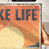 a person holding up a sign that says take life