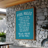 a pool rules sign on a stone wall