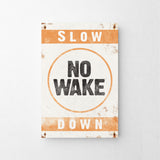 a sign that says slow no wake down