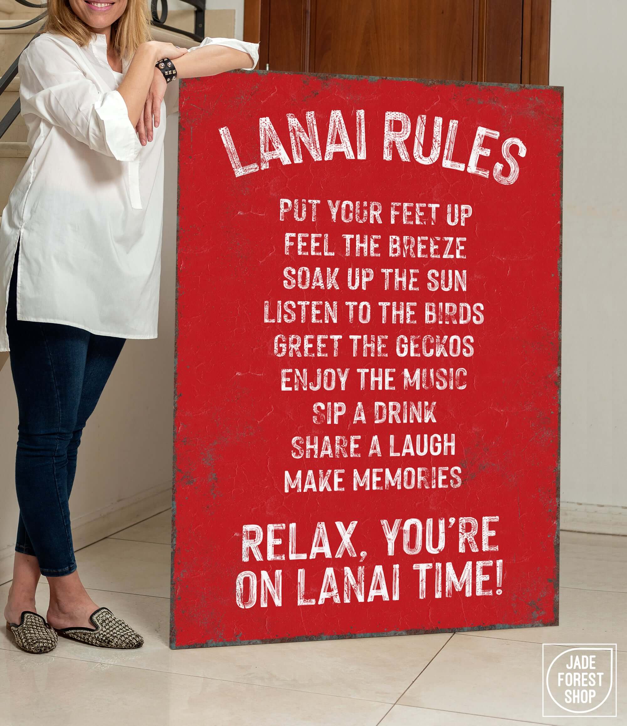 a woman holding a sign that says lanai rules