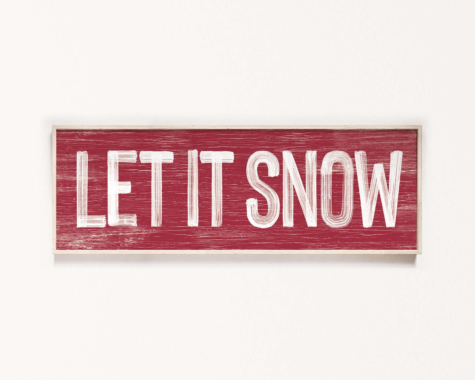 a wooden sign that says let it snow