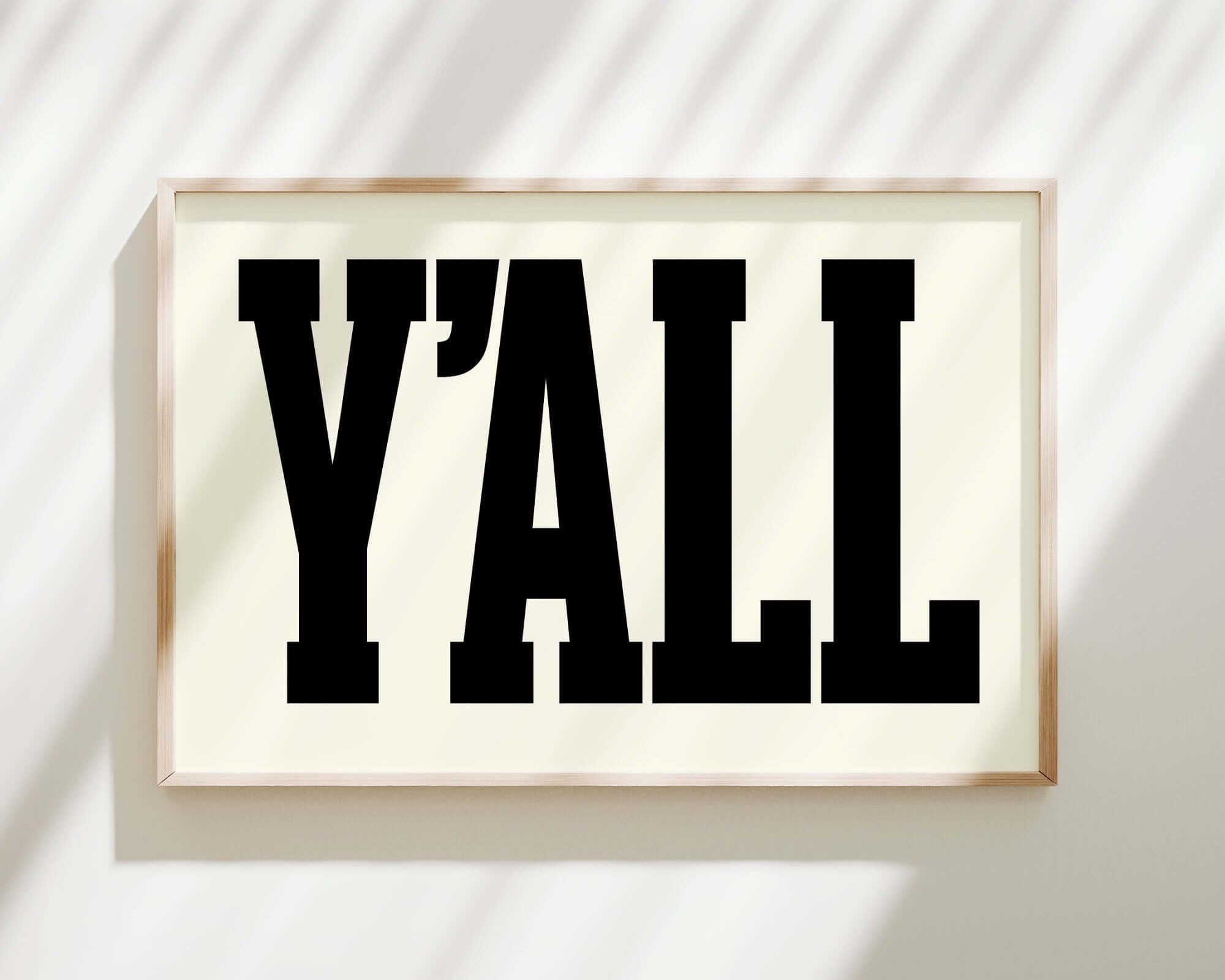 The Y'all Sign Print, Off White, features bold black letters on an off-white background—ideal modern farmhouse decor to add a welcoming touch to your home.