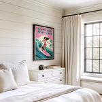 a bedroom with a bed, a dresser, and a window. There is a poster of a woman surfing on the wall above the bed.