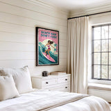 a bedroom with a bed, a dresser, and a window. There is a poster of a woman surfing on the wall above the bed.
