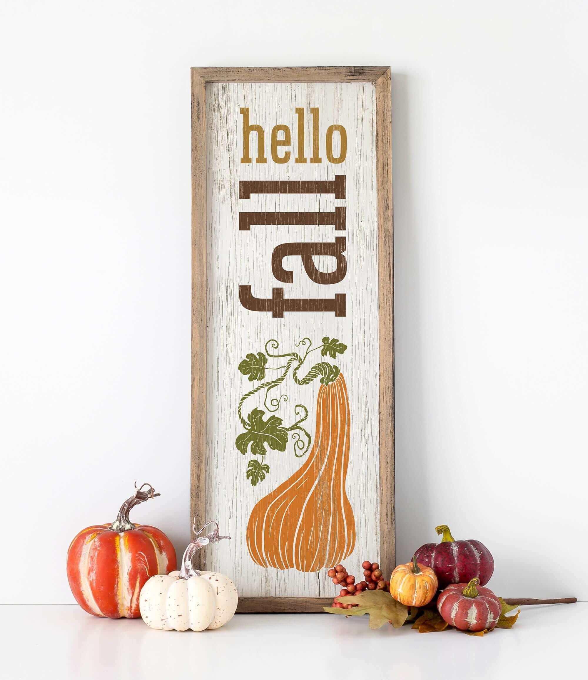 a sign that says hello fall with pumpkins and gourds