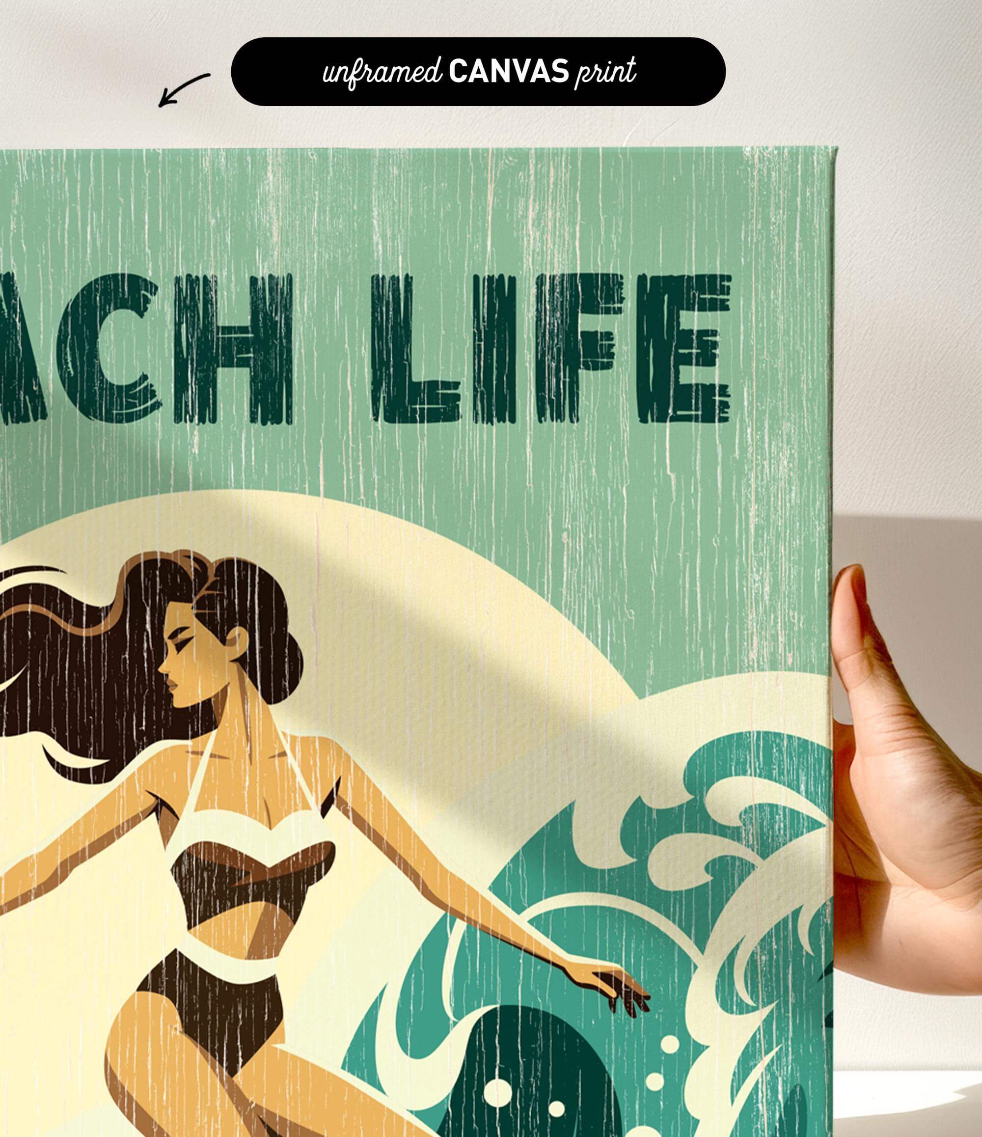 a hand holding a canvas print with a beach life theme, including a woman in a bathing suit and a wave.