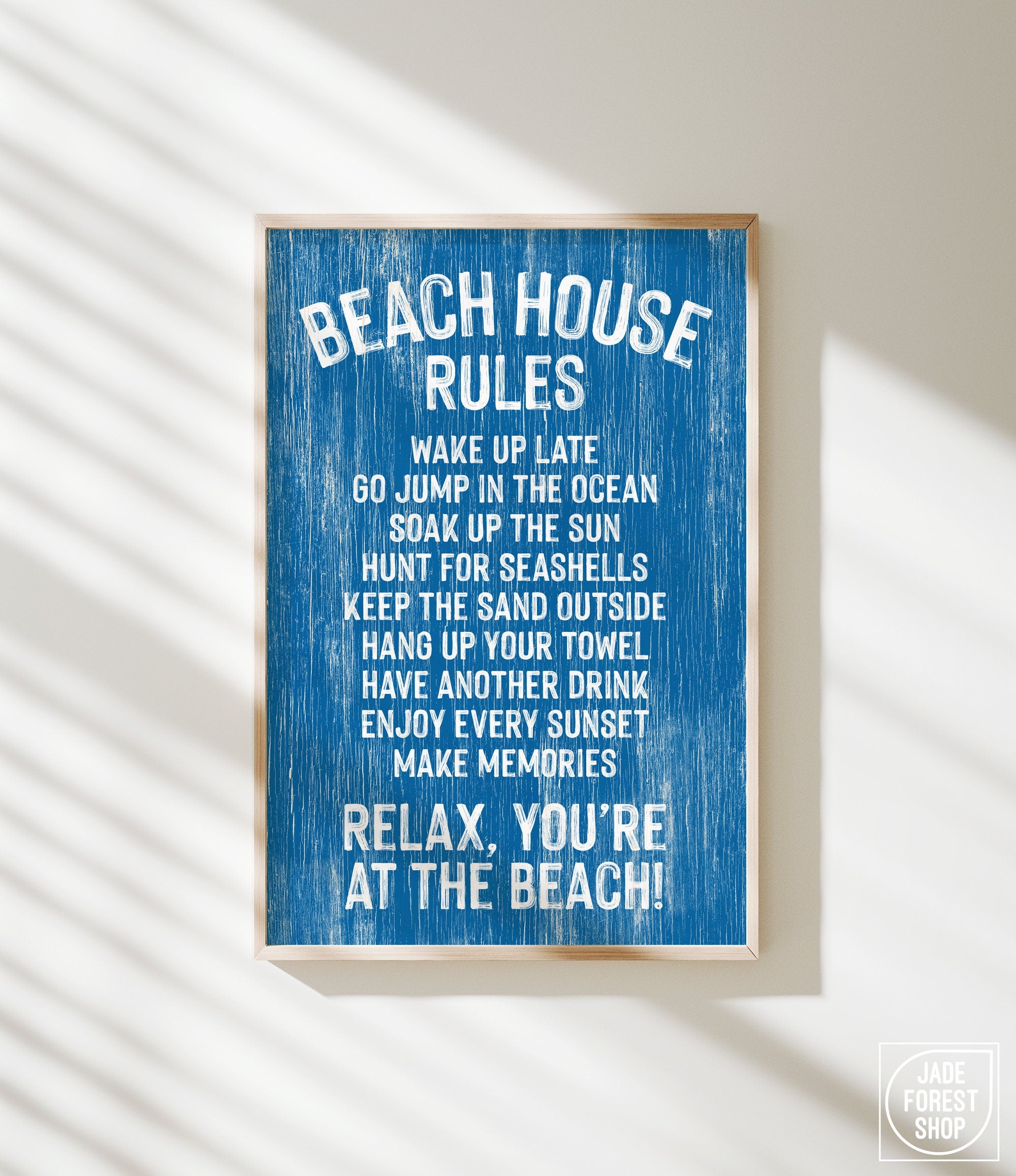 The Beach House Rules Sign in painted wood, ocean blue, features white text with relaxing beach activities—perfect coastal wall art for your space.