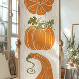 a person holding up a painting of pumpkins