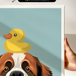 A hand is holding a framed print featuring a cartoon image of a dog with a yellow rubber duck on its head.